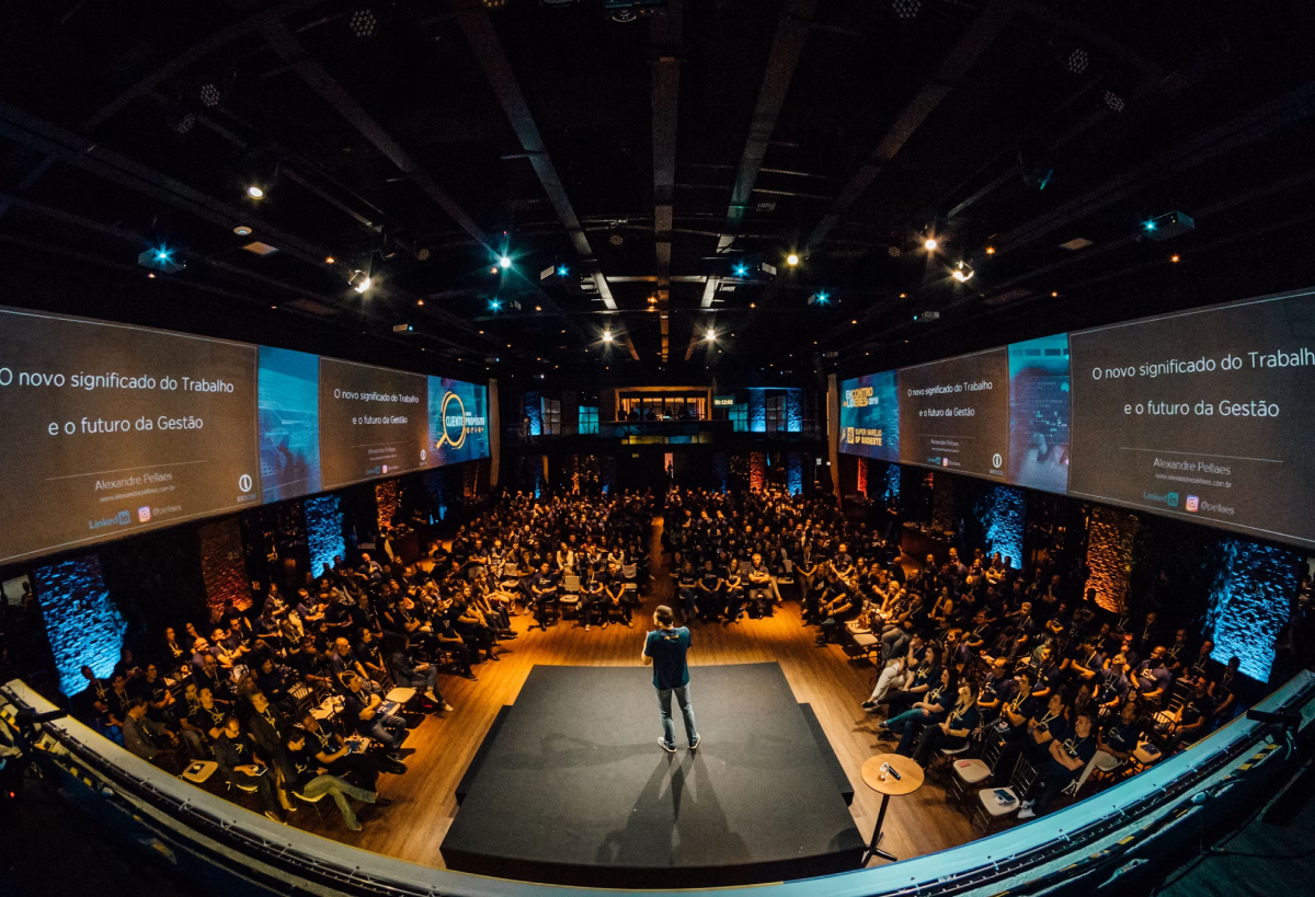 Two colleagues in the office looking at a laptop screen with a smile