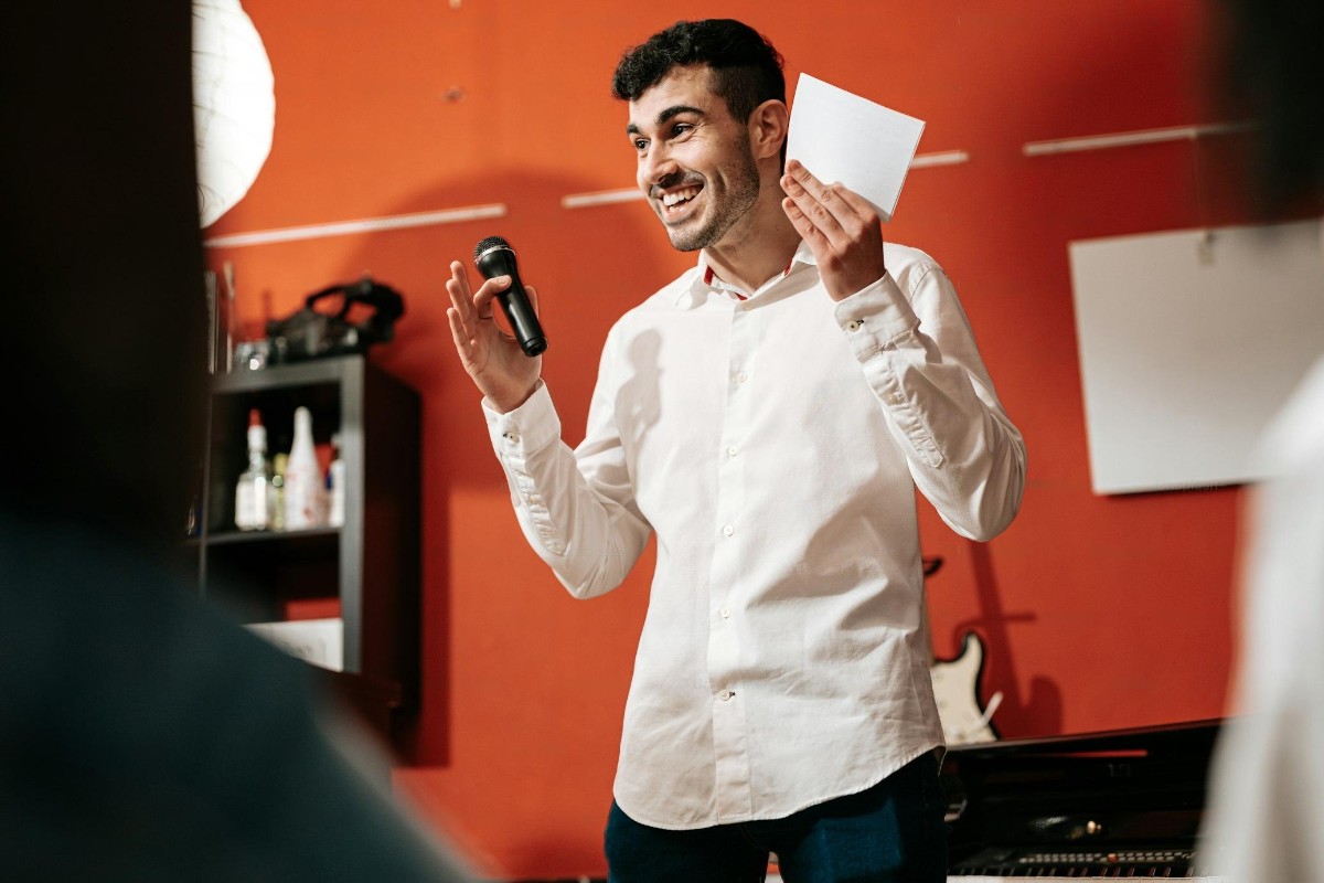 Two colleagues in the office looking at a laptop screen with a smile